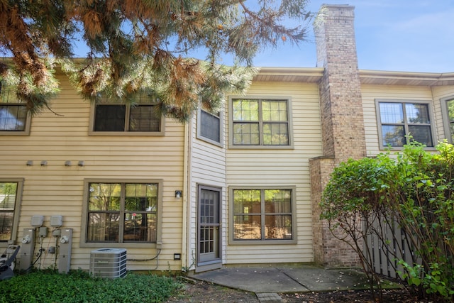 rear view of house featuring a patio and central air condition unit