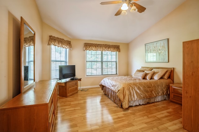 bedroom featuring ceiling fan, light wood-type flooring, and vaulted ceiling