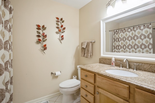 bathroom with vanity, tile patterned flooring, and toilet