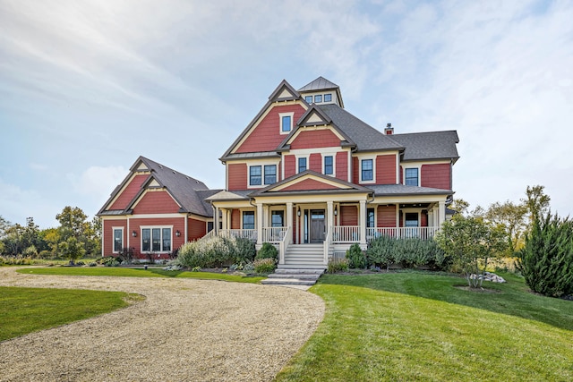 craftsman inspired home featuring a front lawn and covered porch