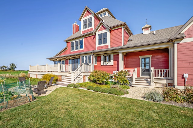 victorian-style house with a front yard and a porch