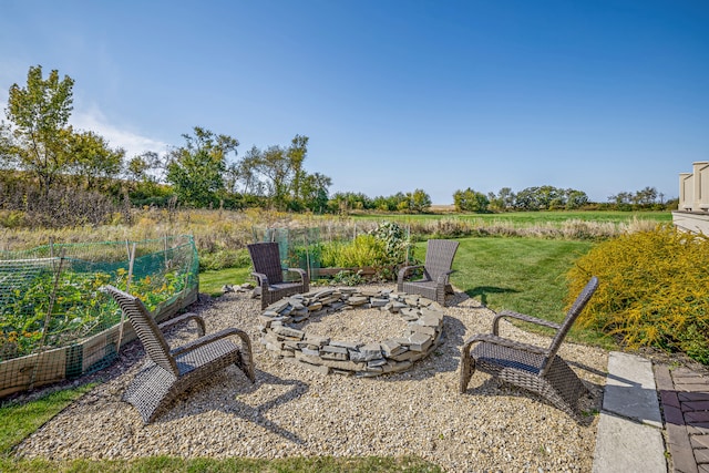 view of patio / terrace featuring a rural view and an outdoor fire pit