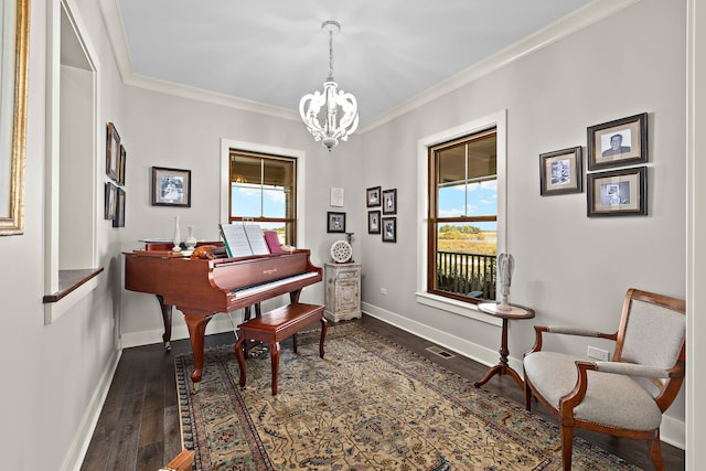 living area featuring dark wood-type flooring, crown molding, and an inviting chandelier