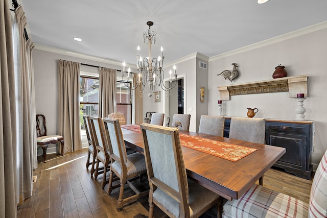 dining room with crown molding, a notable chandelier, and dark hardwood / wood-style floors