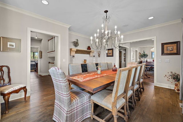 dining area featuring dark wood-type flooring, crown molding, and an inviting chandelier