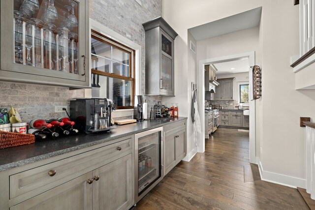 interior space with wine cooler, dark hardwood / wood-style floors, stainless steel range oven, and gray cabinetry