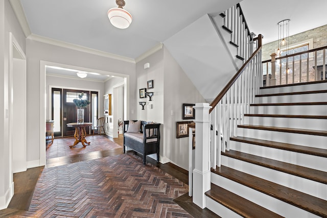 foyer entrance featuring crown molding