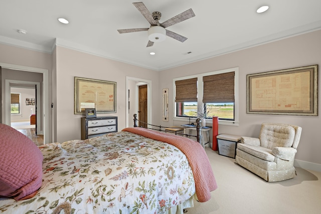 carpeted bedroom featuring ceiling fan and ornamental molding