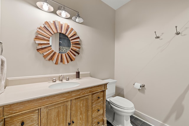 bathroom with vanity, toilet, and tile patterned floors