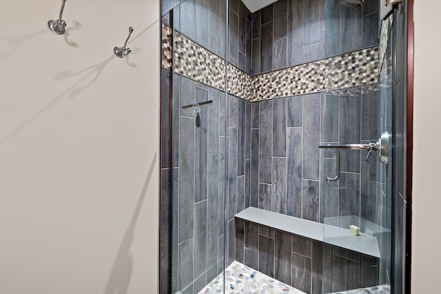 bathroom featuring a shower with door