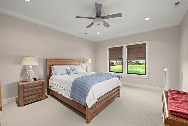 carpeted bedroom featuring crown molding and ceiling fan