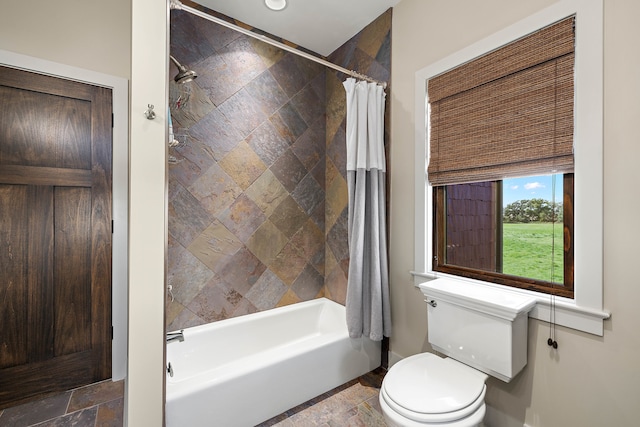 bathroom with toilet and shower / tub combo with curtain