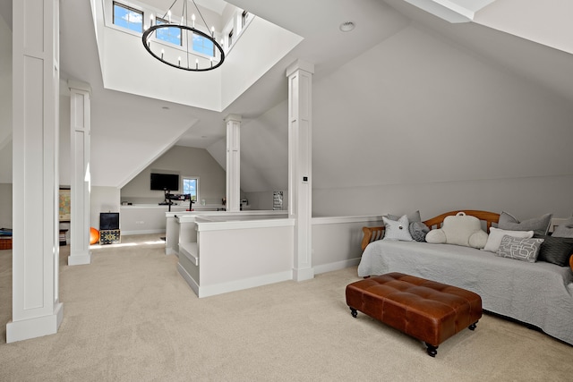 carpeted bedroom with an inviting chandelier and lofted ceiling