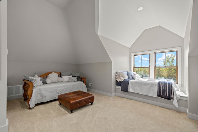 bedroom featuring light carpet and vaulted ceiling