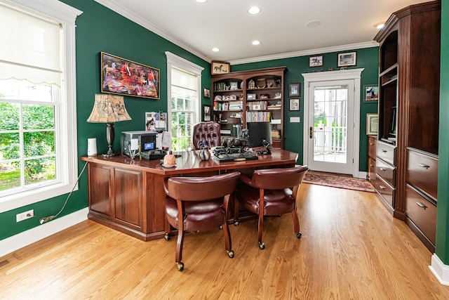 office area with ornamental molding, light wood-type flooring, and plenty of natural light