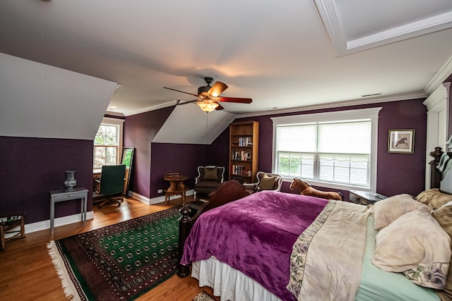 bedroom featuring wood-type flooring, lofted ceiling, ceiling fan, and crown molding