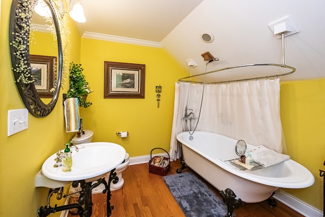 bathroom featuring hardwood / wood-style floors, lofted ceiling, plus walk in shower, ornamental molding, and toilet