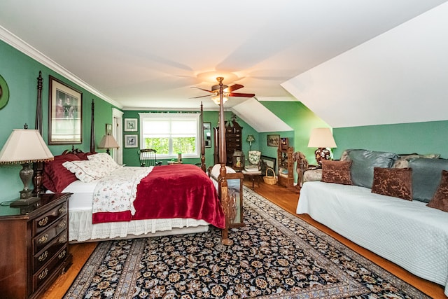 bedroom featuring ornamental molding, vaulted ceiling, ceiling fan, and hardwood / wood-style flooring