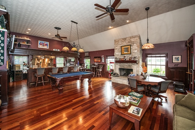 rec room featuring high vaulted ceiling, pool table, ceiling fan, and a stone fireplace