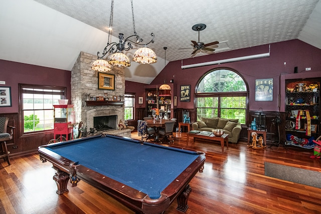 recreation room featuring pool table, lofted ceiling, hardwood / wood-style floors, a stone fireplace, and ceiling fan