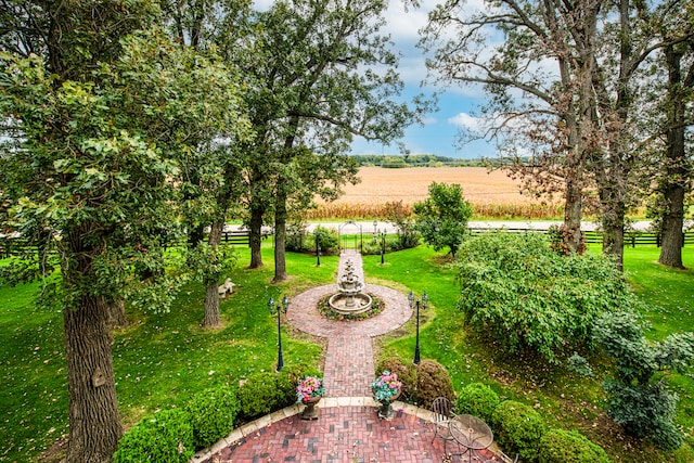 view of home's community featuring a rural view and a yard