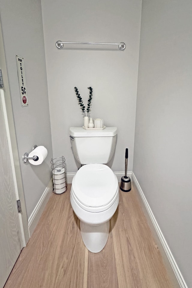 bathroom featuring wood-type flooring and toilet