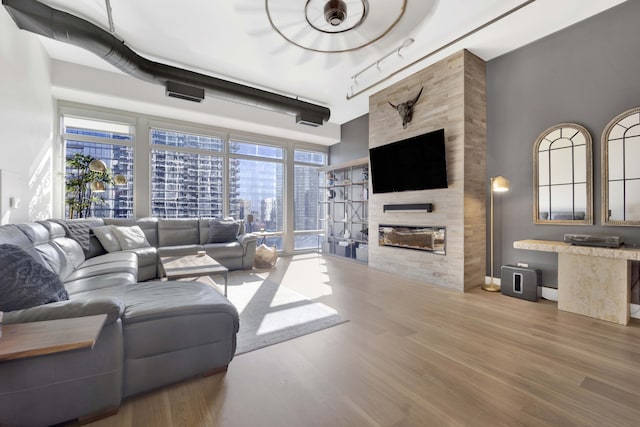 living room with hardwood / wood-style flooring and a fireplace