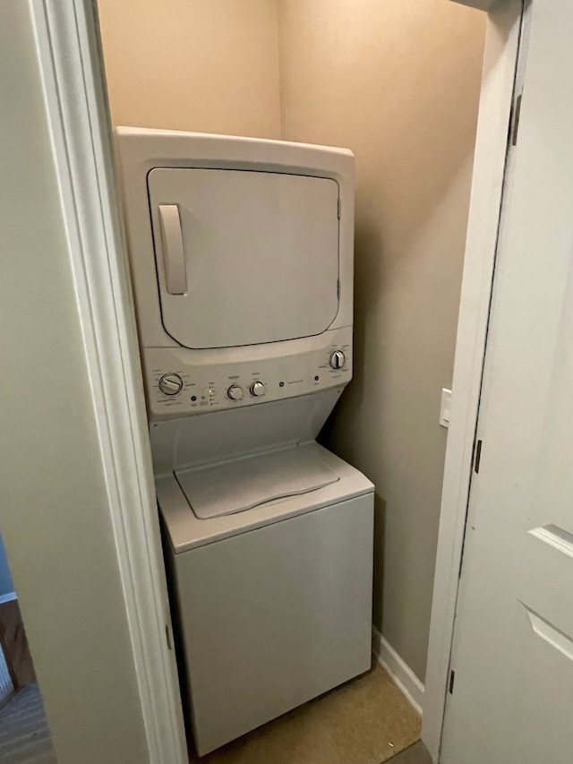 laundry room with stacked washer / drying machine