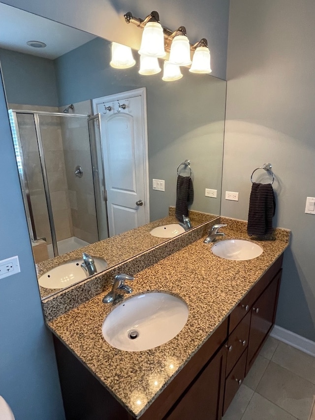 bathroom featuring tile patterned floors, an enclosed shower, and vanity