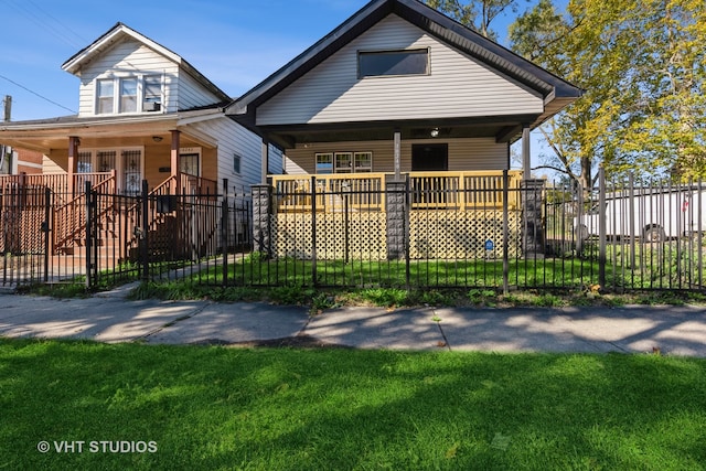 bungalow with covered porch and a front lawn