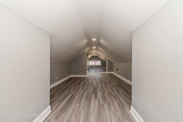 bonus room with vaulted ceiling and wood-type flooring