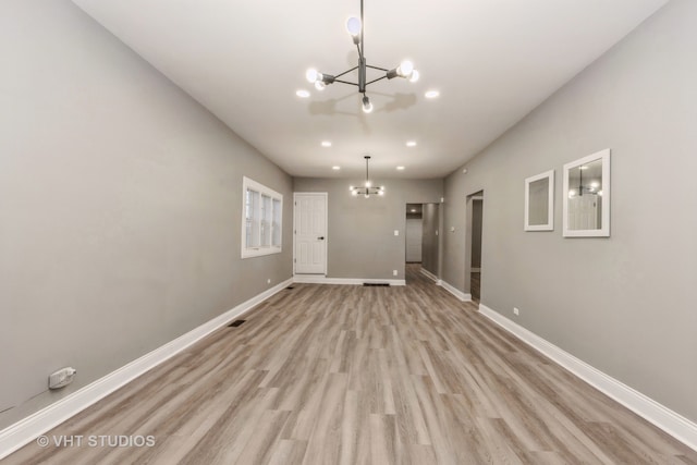 interior space with an inviting chandelier and light wood-type flooring