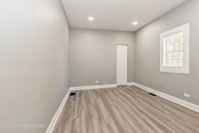 empty room with light hardwood / wood-style flooring