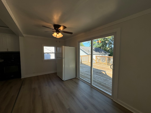 unfurnished living room with a wealth of natural light, ceiling fan, hardwood / wood-style flooring, and crown molding