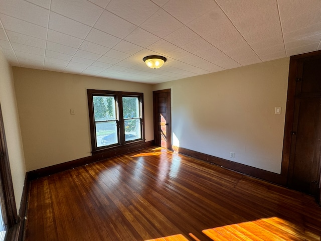 unfurnished room with dark hardwood / wood-style floors