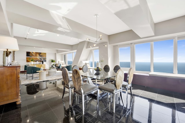 dining space featuring a water view