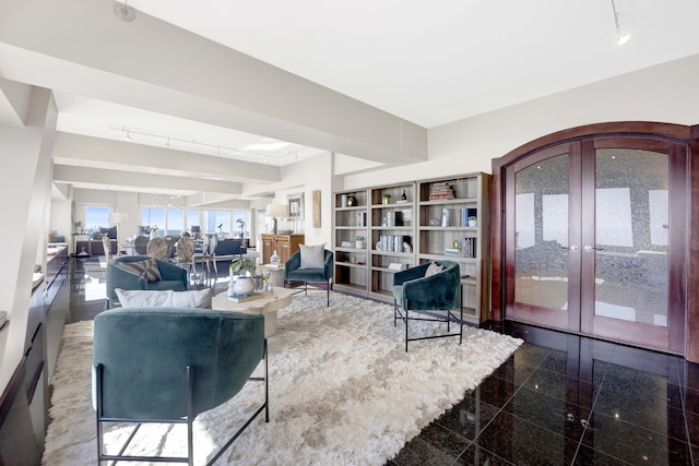 living room featuring french doors and rail lighting