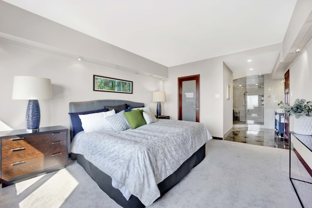 bedroom with light colored carpet and connected bathroom