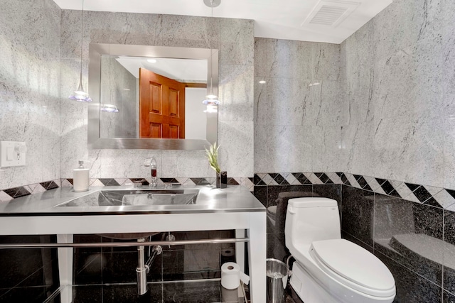 bathroom with vanity, tile walls, backsplash, and toilet