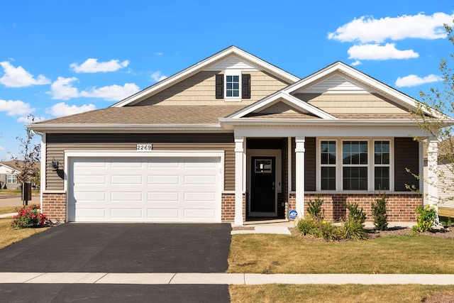 craftsman-style home with a garage and a front lawn