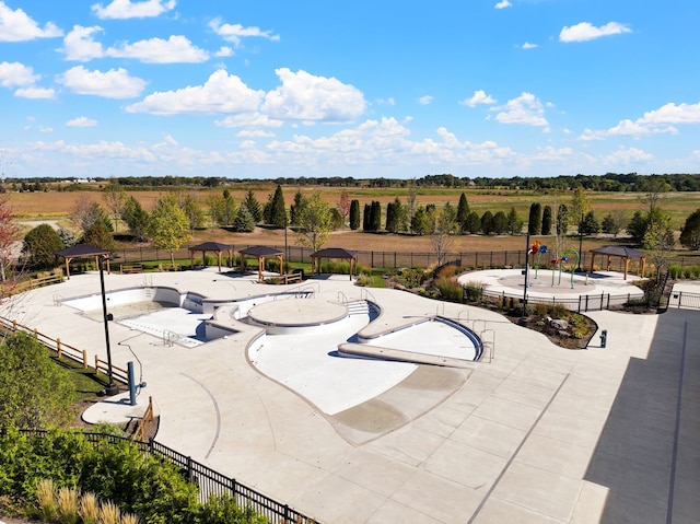 view of swimming pool featuring a rural view and a patio area