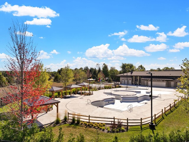 view of pool featuring a gazebo, a yard, a hot tub, and a patio area