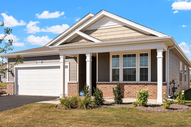 view of front facade with a front yard and a garage