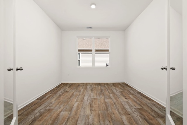 empty room with french doors and hardwood / wood-style floors