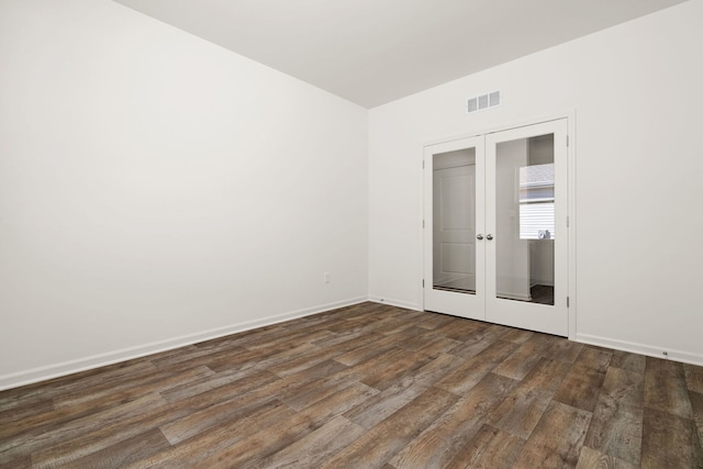 unfurnished room featuring dark hardwood / wood-style floors and french doors