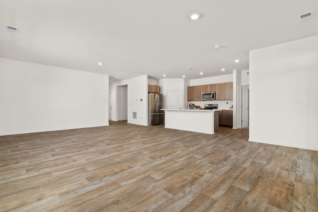 unfurnished living room featuring light hardwood / wood-style flooring