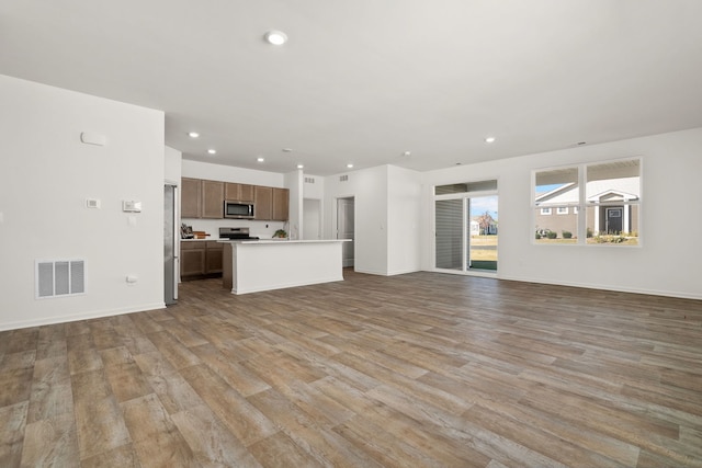 unfurnished living room featuring light hardwood / wood-style floors