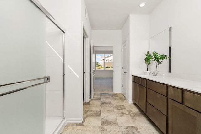 bathroom with vanity and a shower with shower door