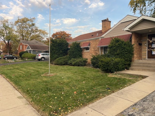 view of side of home with a lawn