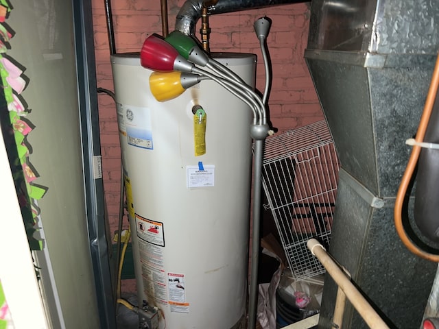 utility room featuring water heater